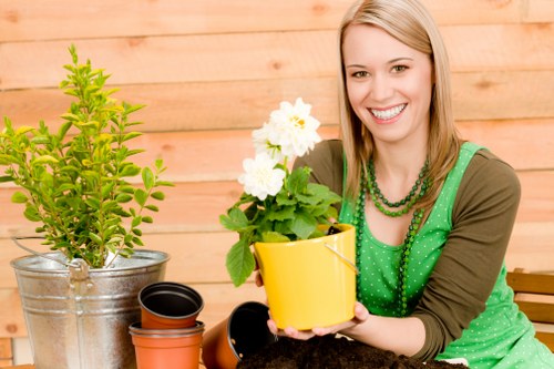 Trainer demonstrating safe equipment use to gardening staff